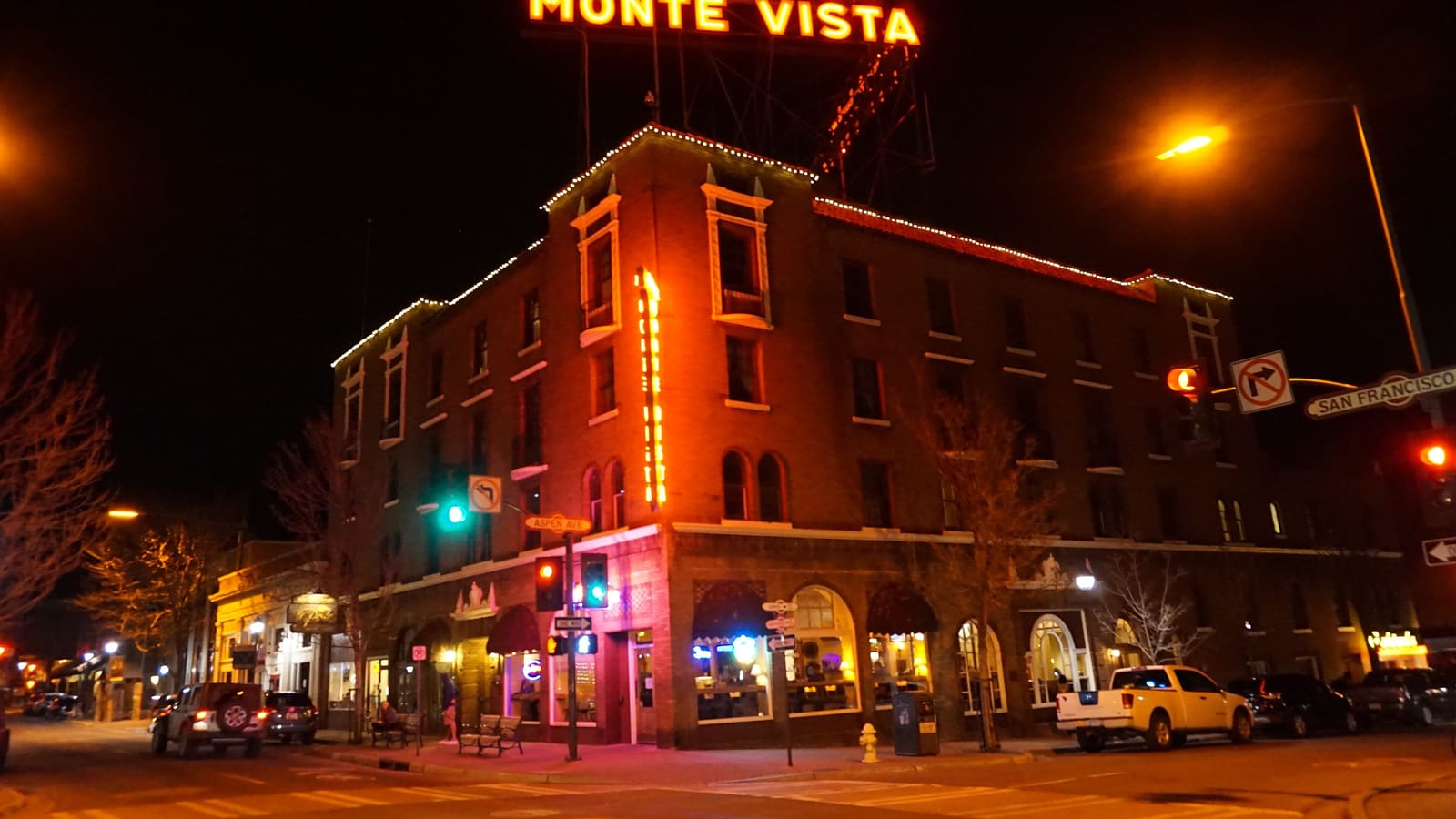 Neon signs lit at night outside the Hotel Monte Vista in downtown Flagstaff