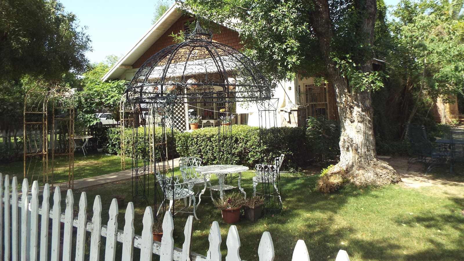 A garden gazebo and white picket fence outside a historic bungalow in Glendale's Catlin Court Historic District, one of the city's most photogenic corners