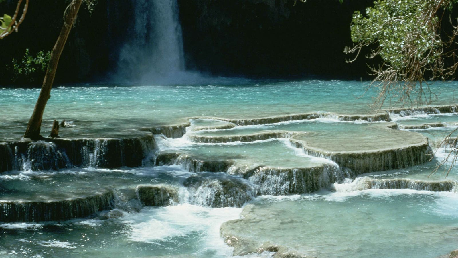 The blue-green cascade of Havasu Falls in the lower Grand Canyon