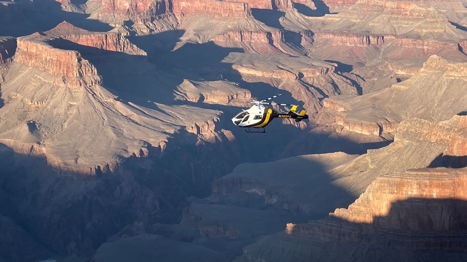 A helicopter flying over the Grand Canyon