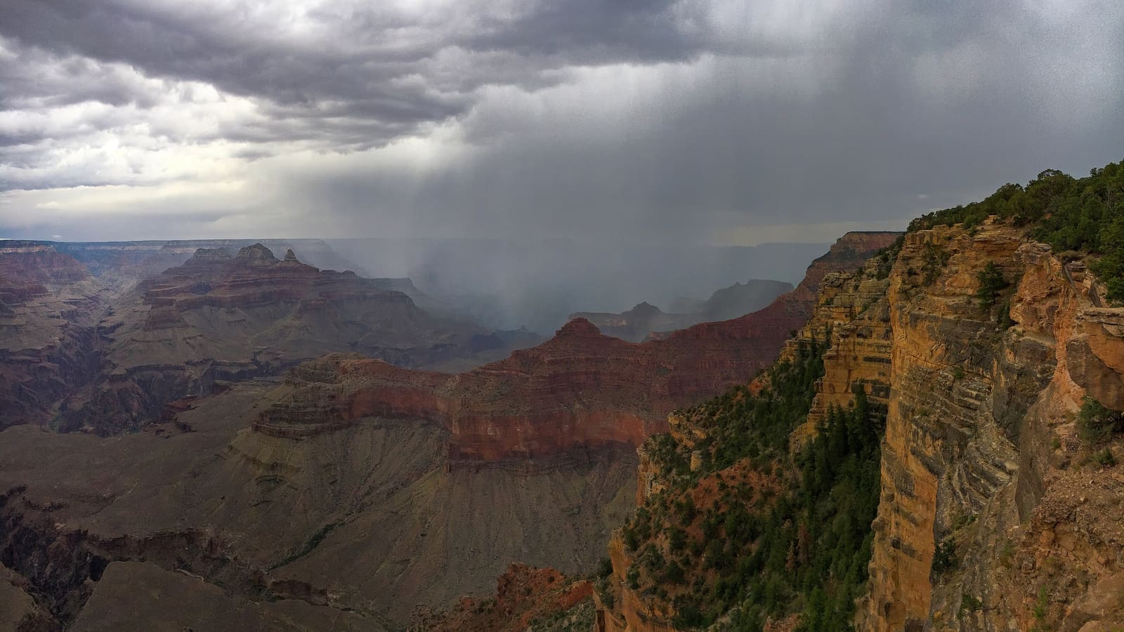 Summer monsoon showers moving across the Grand Canyon at Yavapai Point