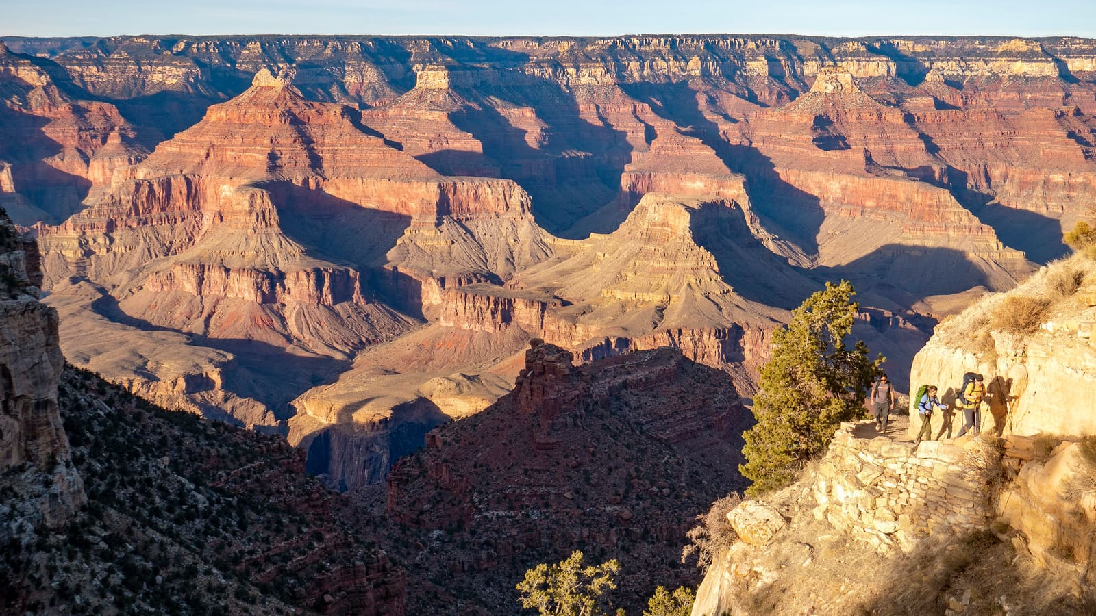 Hikers with backpacks climbing the Bright Angel Trail in the Grand Canyon