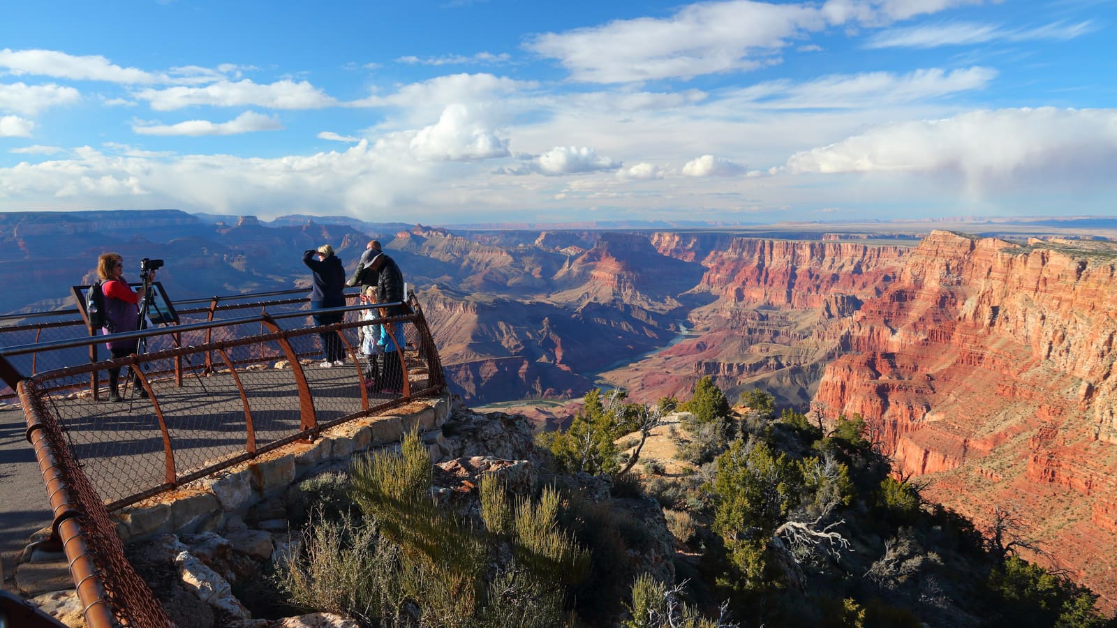 Visitors on the railed viewpoint terrace at Navajo Point on the Grand Canyon's South Rim