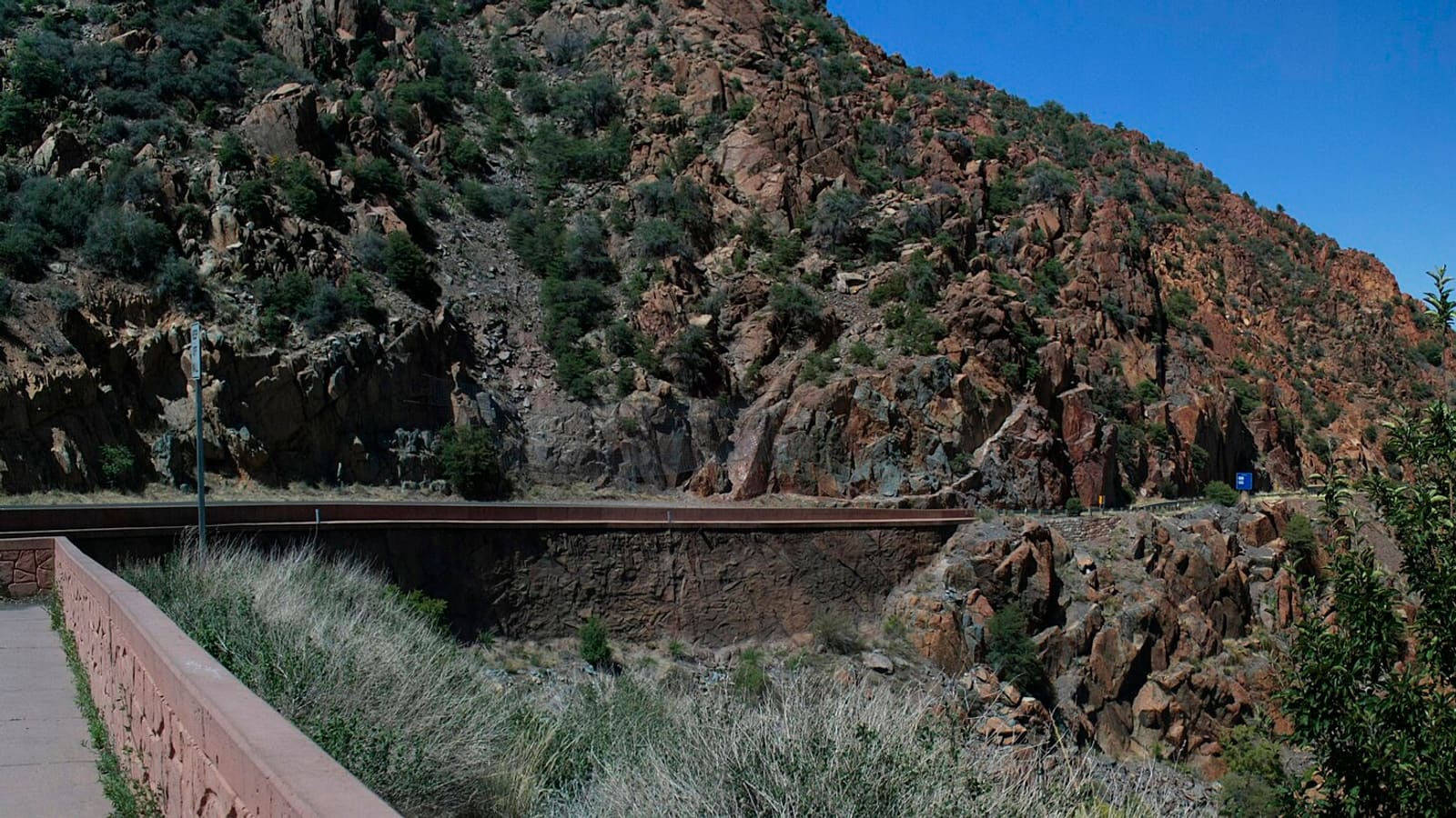 A panoramic viewpoint along Arizona State Route 89A near Jerome, showing the highway's mountainside switchbacks.