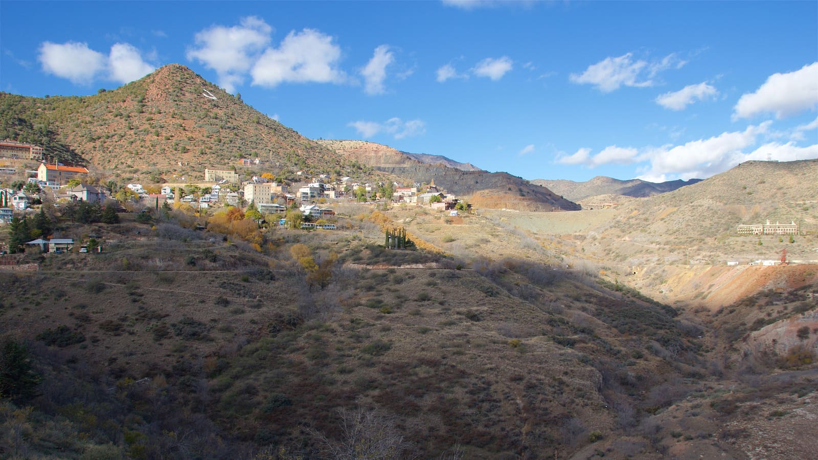 Jerome, Arizona's historic buildings clustered on the hillside above the Verde Valley, seen from across the canyon.