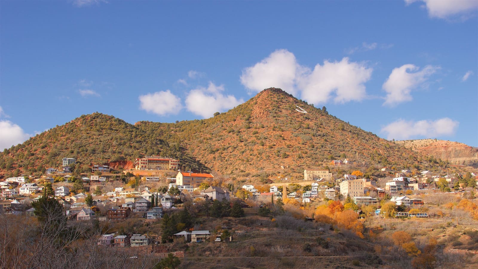 Jerome, Arizona's hillside buildings surrounded by autumn-colored trees above the Verde Valley, photographed in late November.
