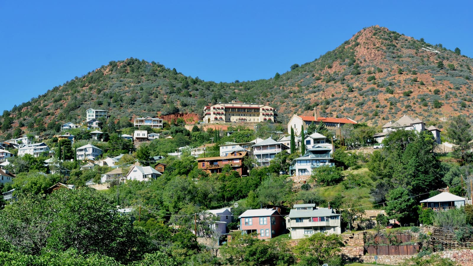 A view of Jerome, Arizona's historic buildings terraced along a steep hillside above the Verde Valley.