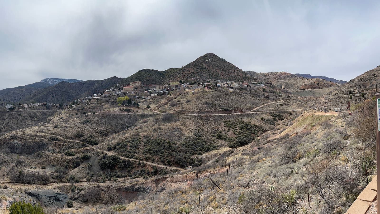 A high-resolution panoramic view of Jerome, Arizona, spread across a steep hillside overlooking the Verde Valley below.