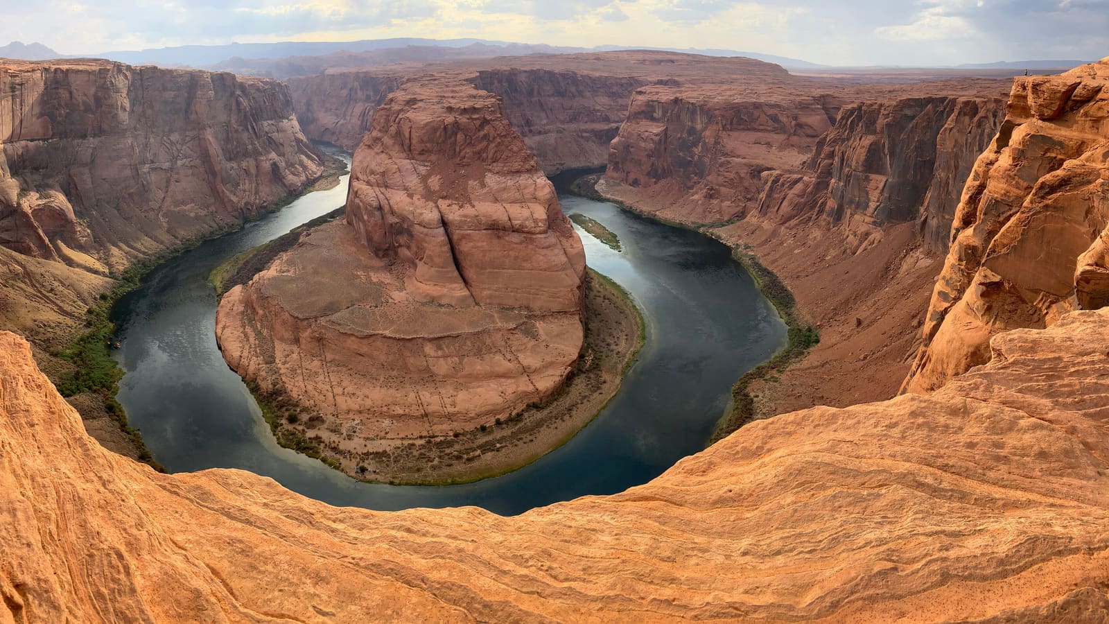The Colorado River curving around the sandstone rim at Horseshoe Bend near Page, Arizona