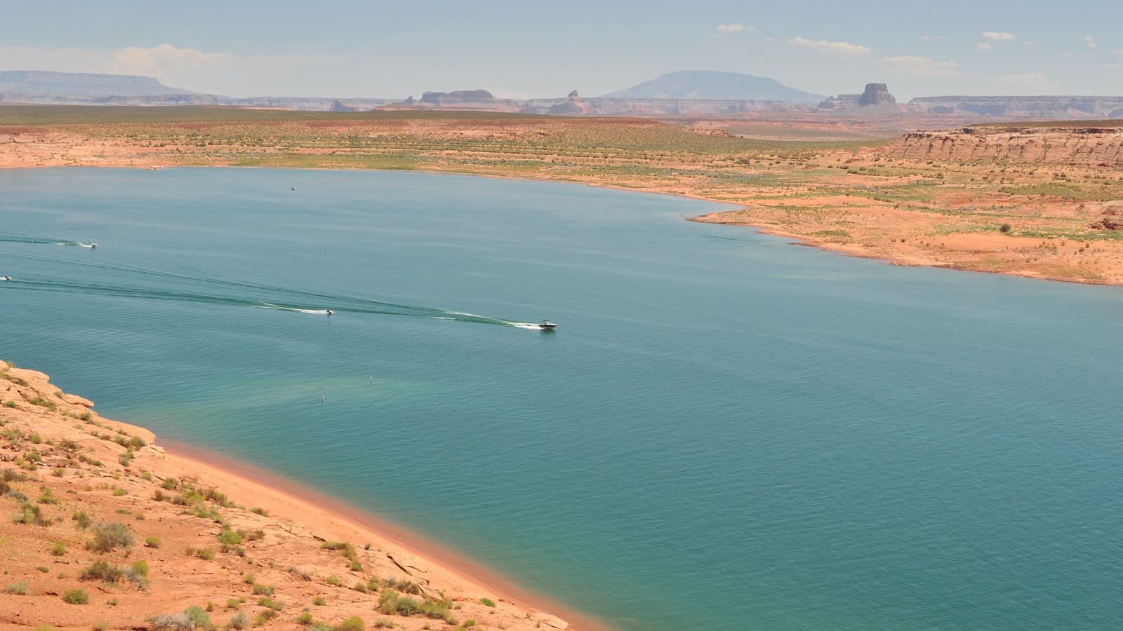 A powerboat cutting across the open water of Lake Powell