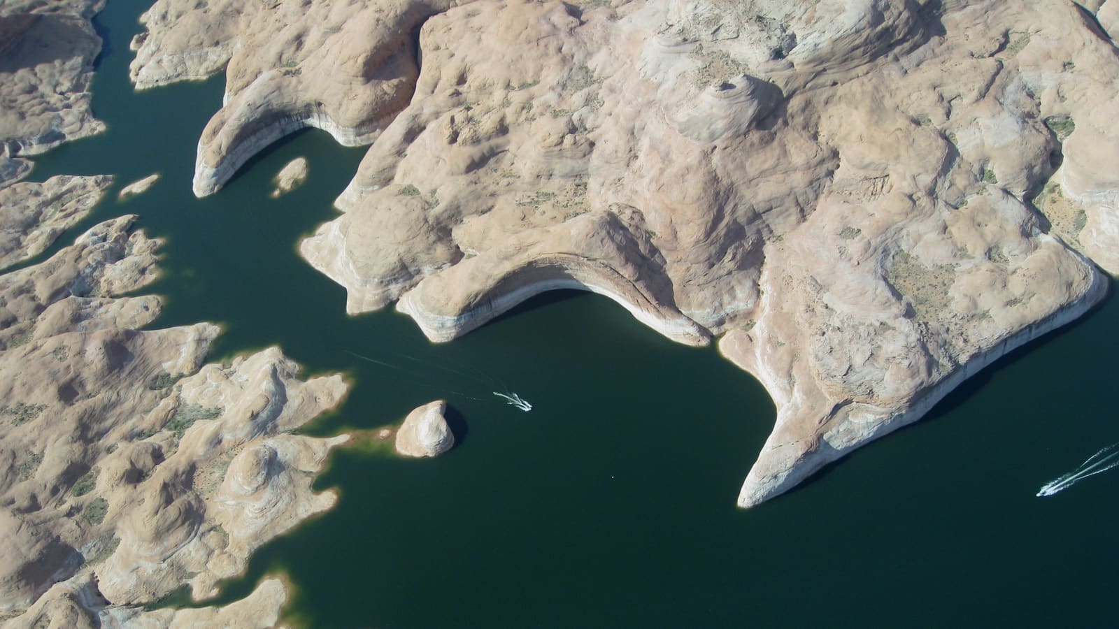 An aerial view of Lake Powell's canyons and blue water from above