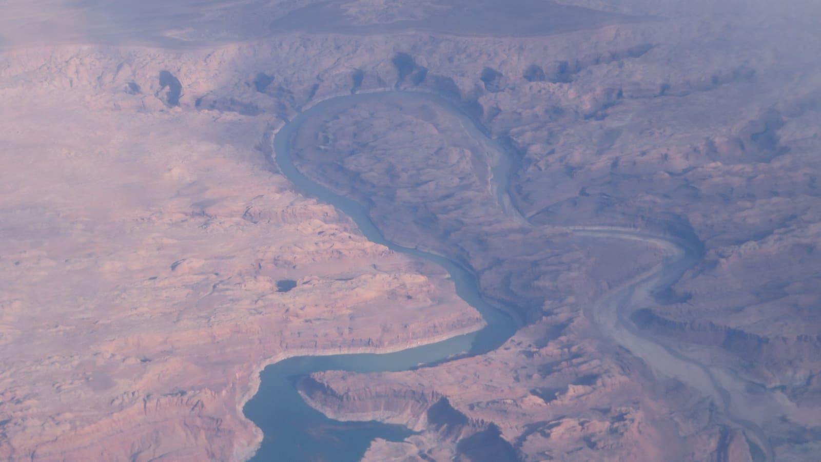 Aerial view of the Great Bend, where the San Juan Arm of Lake Powell curves through layered red-rock canyon walls