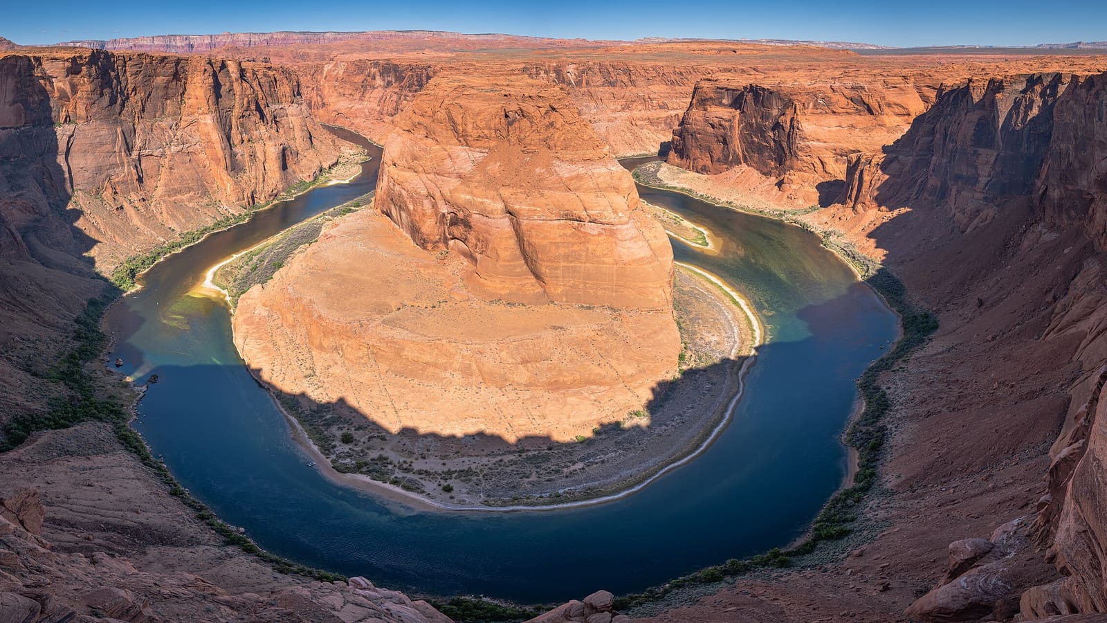 Wide view of the Colorado River curving around Horseshoe Bend from the rim overlook near Page, Arizona