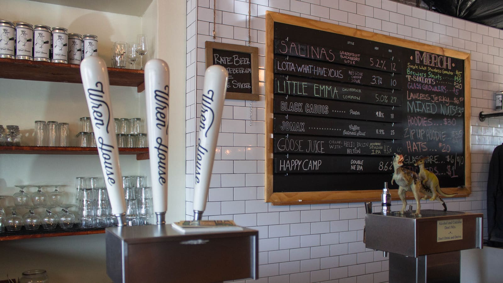 Tap handles reading "Wren House" and a chalkboard beer menu at Wren House Brewing Company in Phoenix, Arizona