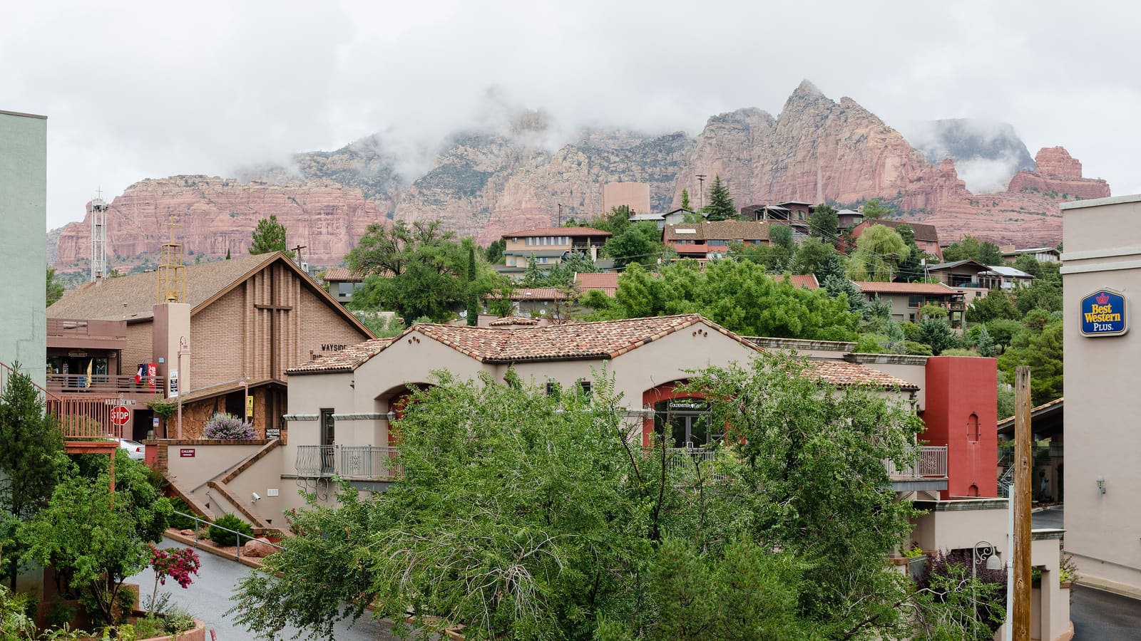 A wide view of Sedona, Arizona, showing multiple neighborhoods amid the red rocks