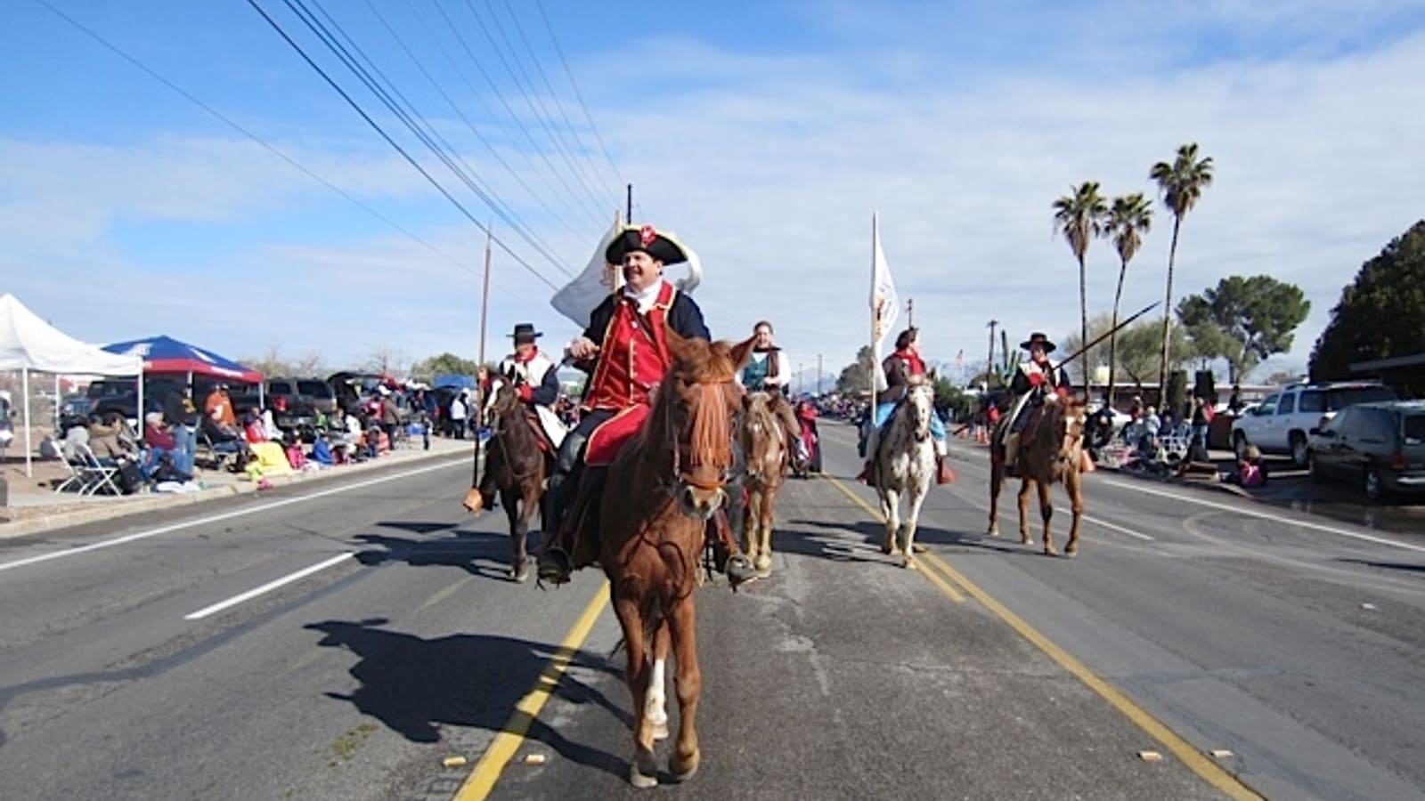 Riders in Spanish colonial-era costume process on horseback in the 2013 Tucson Rodeo Parade, part of La Fiesta de los Vaqueros.