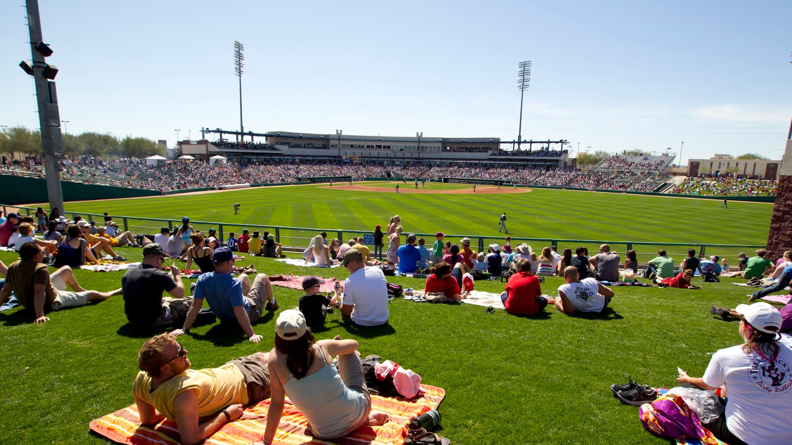 Fans on the outfield lawn during a Cactus League spring training game at Kino Stadium, Tucson