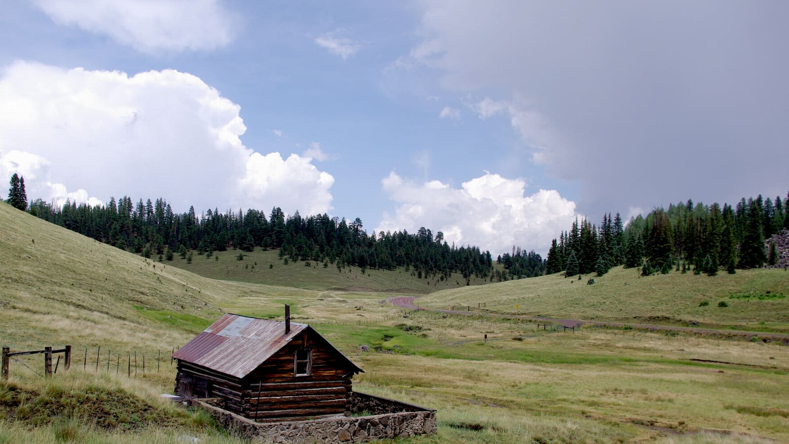 A green alpine meadow and cabin near Big Lake in Arizona's White Mountains